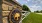 stone pillar and fence with property sign